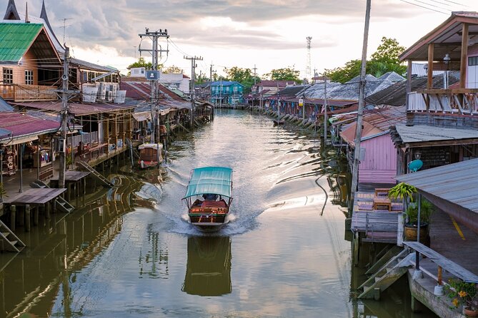 Amphawa Floating Market & Maeklong Railway Train Market Tour - Wat Bang Kung: Buddha statues wrapped by banyan roots