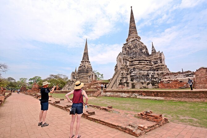 Ayutthaya Sunset Tour: UNESCO Temples & Peaceful River Cruise - Wat Mahathat: The Buddha Head in Tree Roots Moment