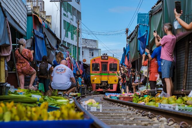 Damnoen Saduak Floating Market and Maeklong Railway Market Tour - Maeklong Railway Market (Talad Rom Hoop): the train’s schedule is the show