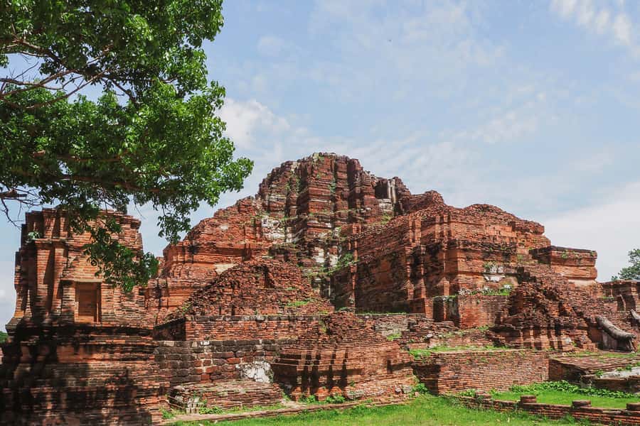 From Bangkok: Ayutthaya Day Tour by Bus with River Cruise - Wat Mahathat: the tree roots and a Buddha head tangled in place