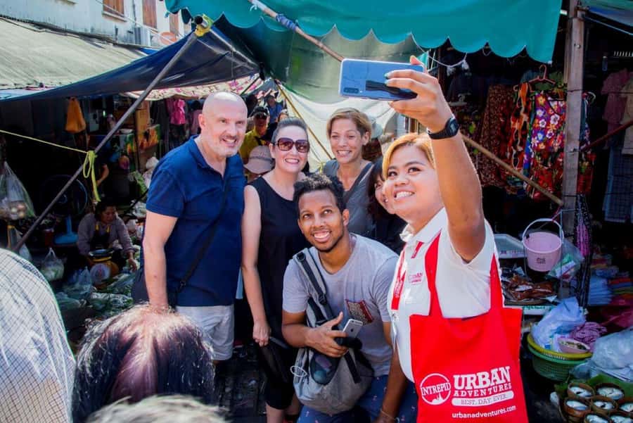 From Bangkok: Private Railway and Floating Market Tour - The railway market where vendors work inches from the track